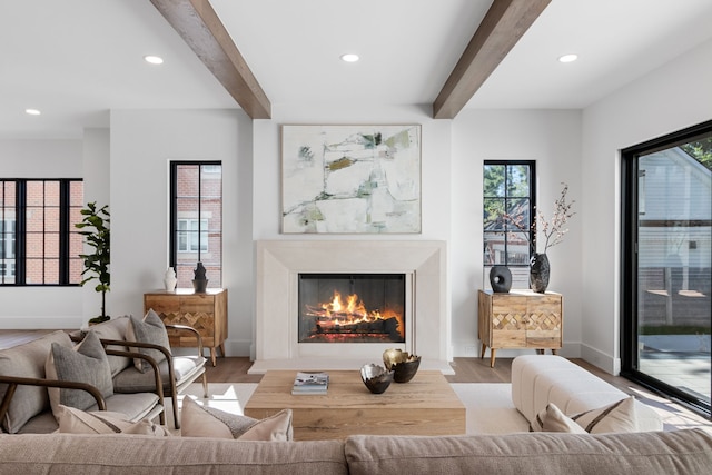 living room with beamed ceiling and light hardwood / wood-style flooring