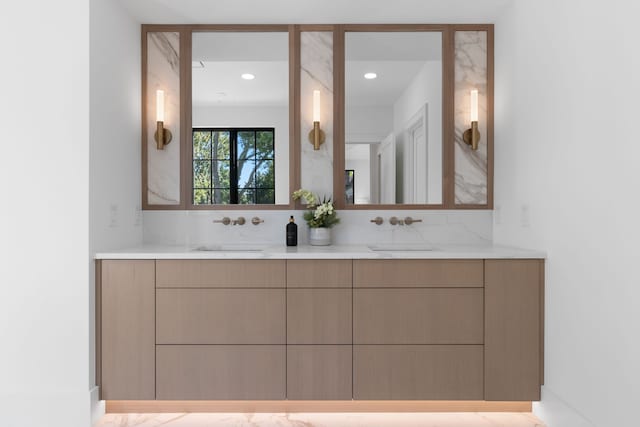 bathroom featuring vanity and tasteful backsplash