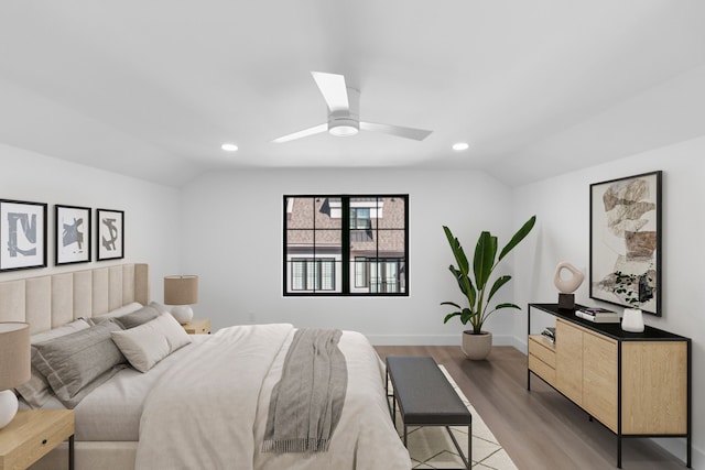 bedroom with hardwood / wood-style floors, ceiling fan, and vaulted ceiling