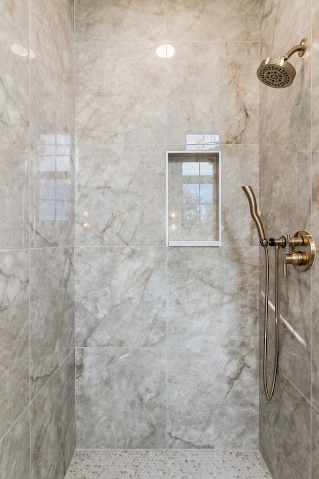 bathroom with tiled shower