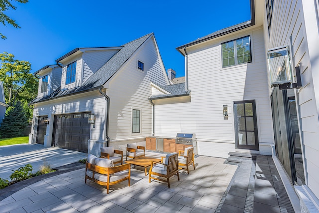 rear view of property with a patio area, an outdoor living space, and a garage