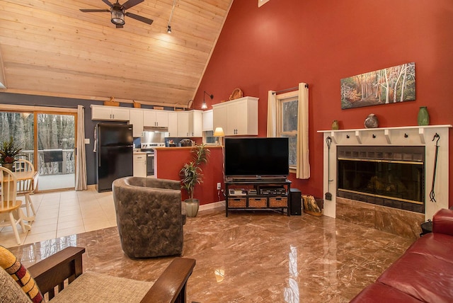 living room with a tile fireplace, high vaulted ceiling, ceiling fan, and wooden ceiling