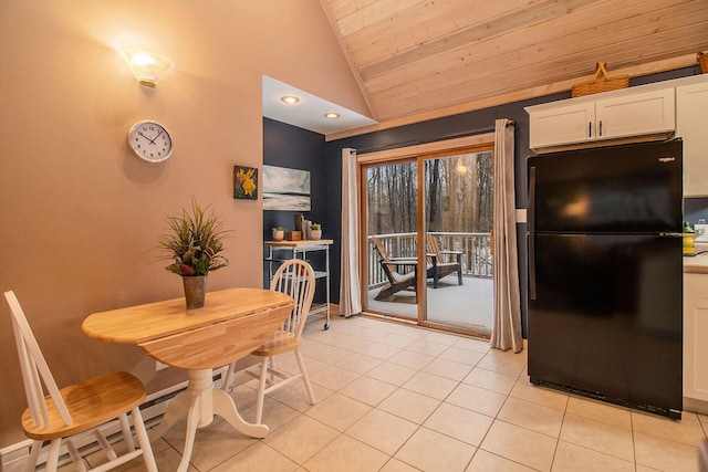 tiled dining space with wood ceiling and high vaulted ceiling