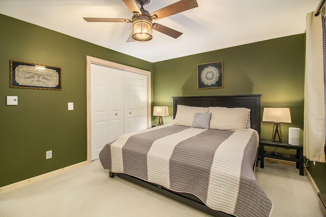 bedroom with light carpet, a closet, and ceiling fan