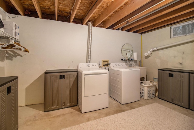 clothes washing area with washer and dryer and sink