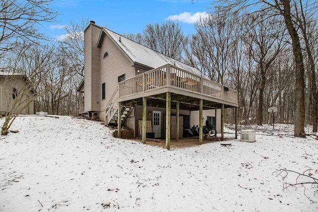 snow covered property featuring a wooden deck