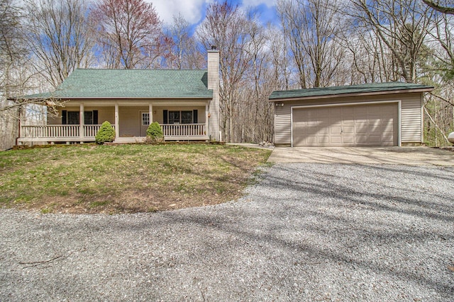 4714 N Lincoln Rd, Ludington, MI 49431 - ranch-style home with a porch, a garage, driveway, and a chimney