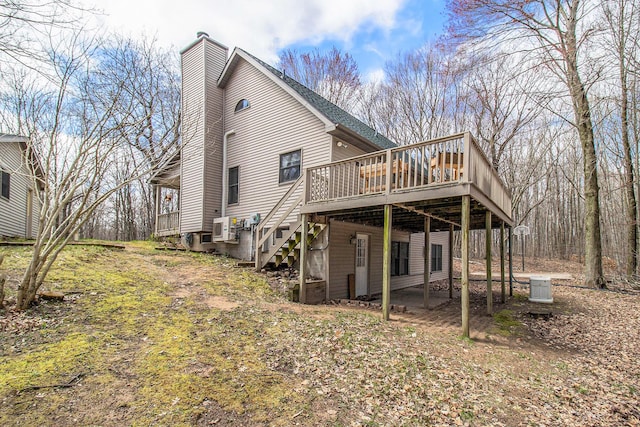 4714 N Lincoln Rd, Ludington, MI 49431 - back of house featuring stairway, a wooden deck, and a chimney