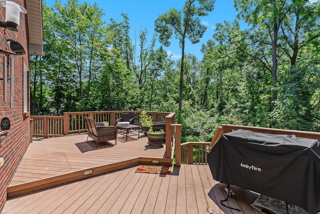 wooden deck featuring a grill