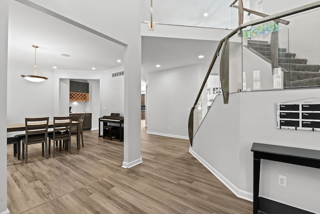 foyer with hardwood / wood-style floors and ornamental molding