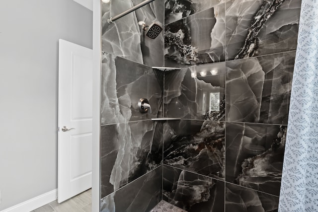 bathroom with a tile shower