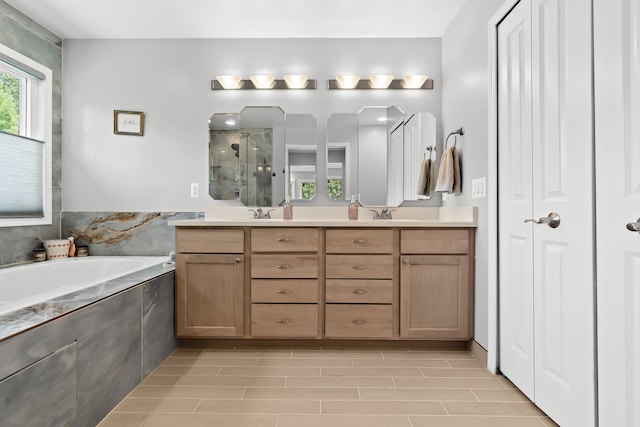 bathroom with vanity and independent shower and bath