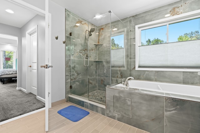 bathroom featuring tile patterned floors, a wealth of natural light, and independent shower and bath