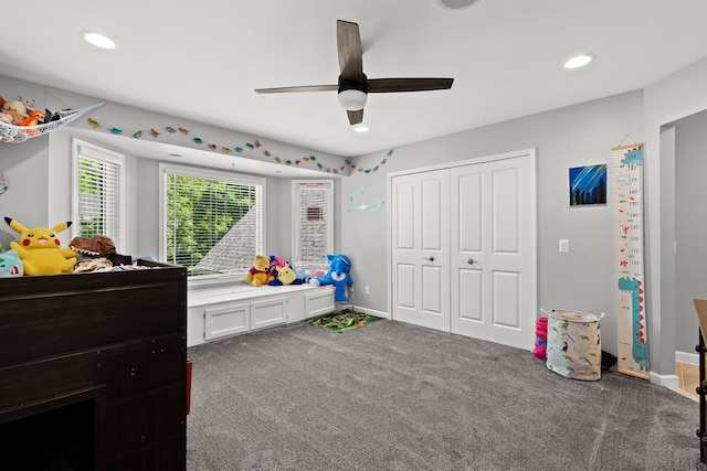 carpeted bedroom featuring a closet and ceiling fan