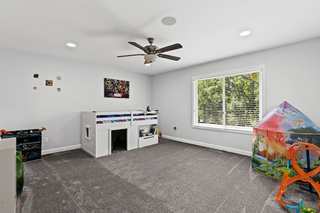 rec room with dark colored carpet and ceiling fan