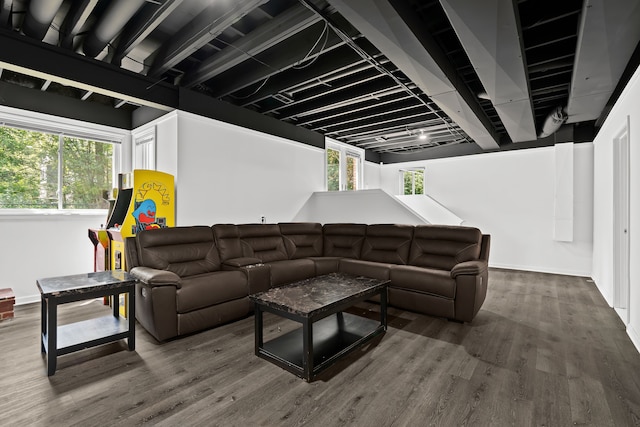 living room with plenty of natural light and dark wood-type flooring