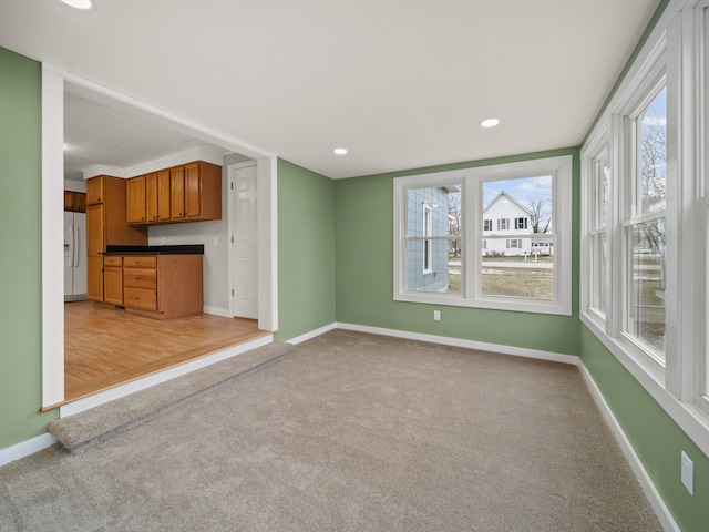 unfurnished living room with light carpet