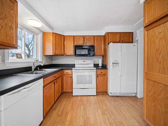 kitchen with white appliances, light hardwood / wood-style flooring, and sink