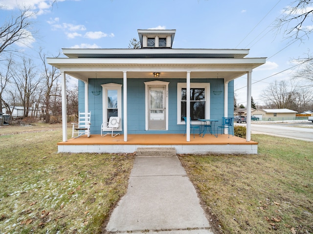 view of front of house with a front lawn and a porch