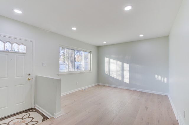 foyer entrance with light hardwood / wood-style floors