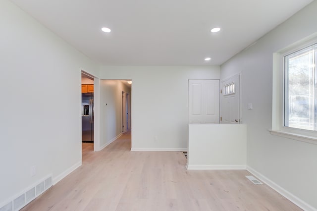 unfurnished room featuring light wood-type flooring