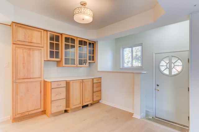 kitchen with light brown cabinetry and light hardwood / wood-style flooring