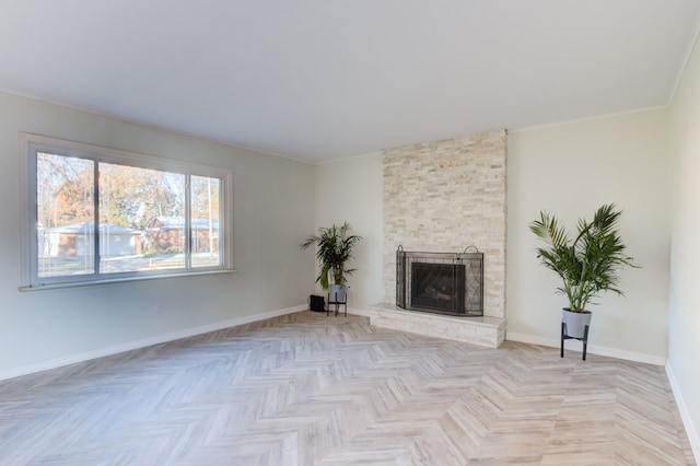 unfurnished living room featuring a stone fireplace and light parquet floors