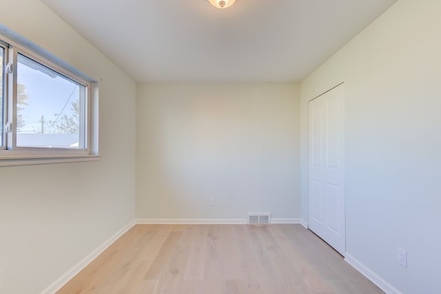 empty room with light hardwood / wood-style floors