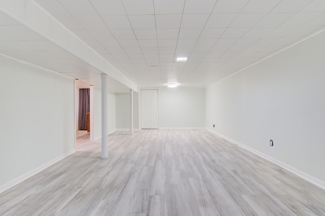 basement with light hardwood / wood-style flooring