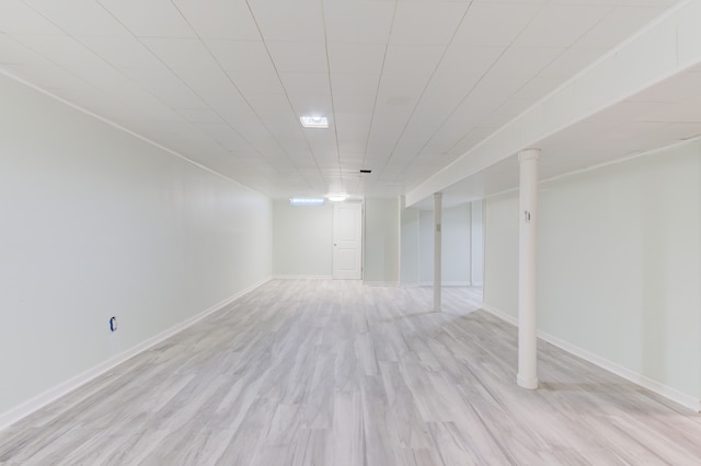 basement with light hardwood / wood-style flooring