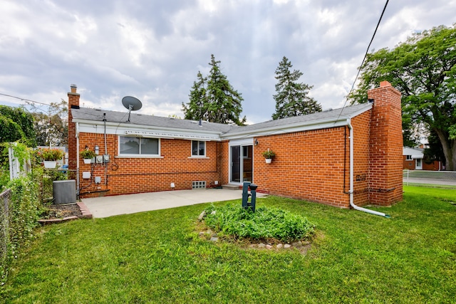 back of house with a lawn, cooling unit, and a patio