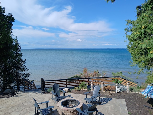 view of patio / terrace featuring a fire pit and a water view