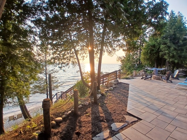 exterior space featuring a water view and fence