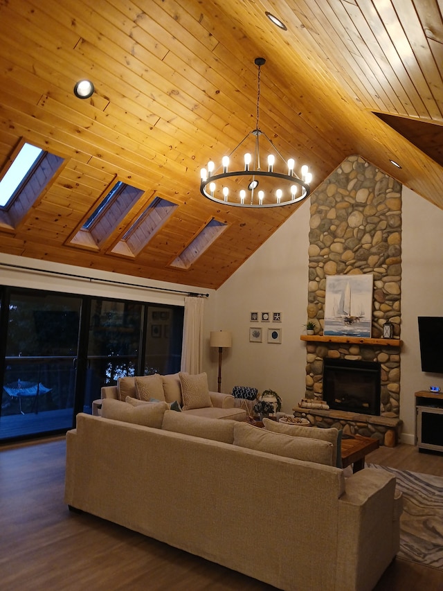 living area featuring wood finished floors, a stone fireplace, a skylight, an inviting chandelier, and wood ceiling