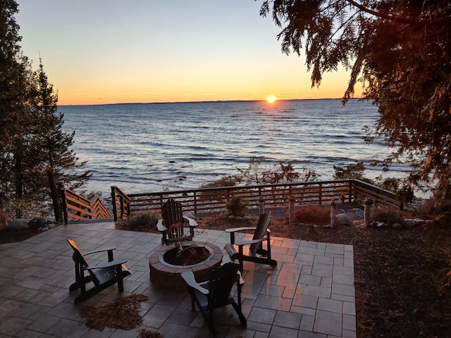 view of patio / terrace featuring a water view and an outdoor fire pit