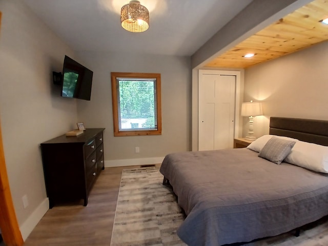 bedroom with baseboards and wood finished floors