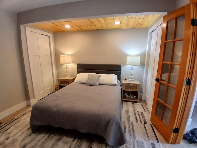 bedroom with recessed lighting, light wood-style flooring, baseboards, and wooden ceiling