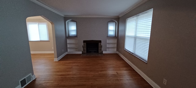 unfurnished living room with crown molding and dark hardwood / wood-style floors