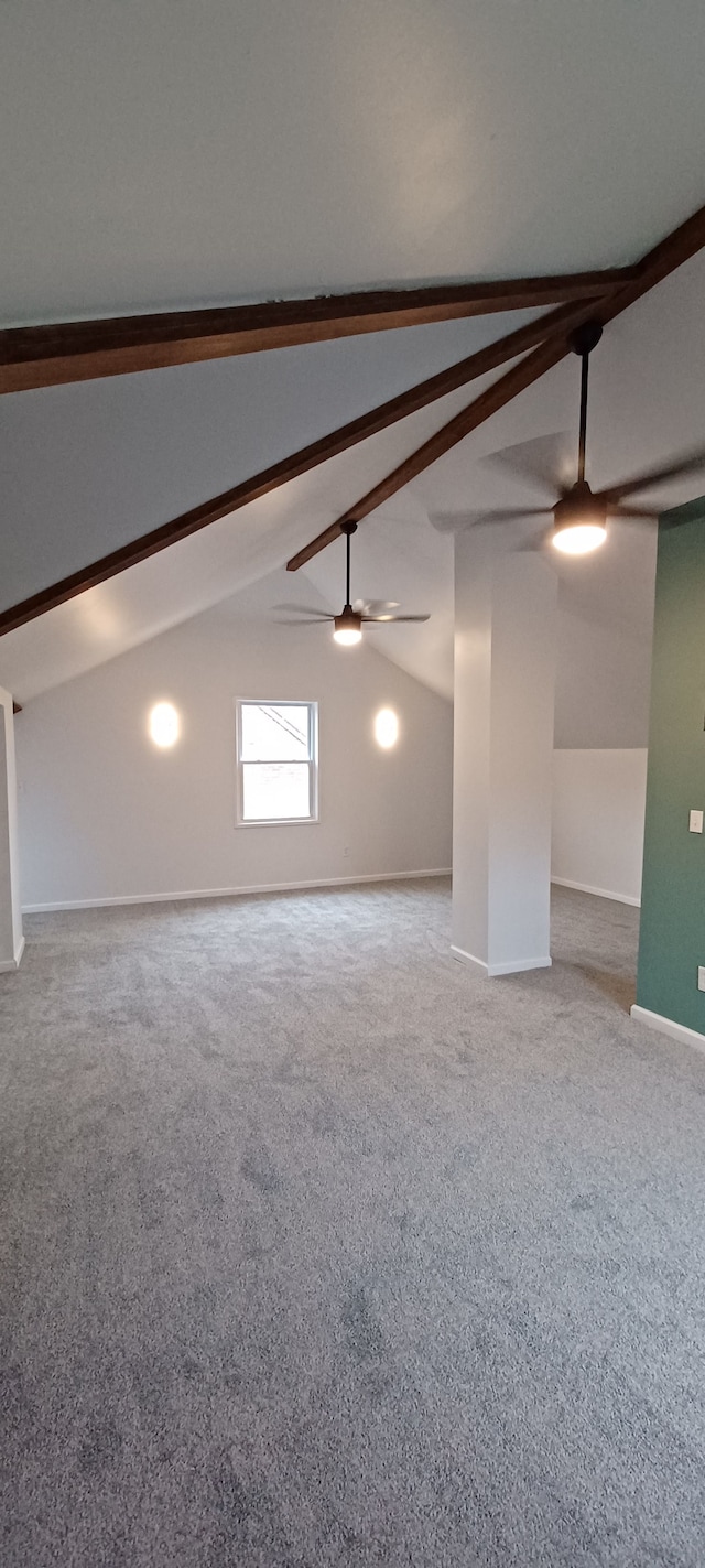 unfurnished room featuring vaulted ceiling with beams, carpet floors, and ceiling fan