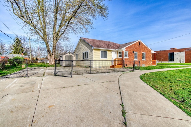 view of side of home with a yard and a storage unit