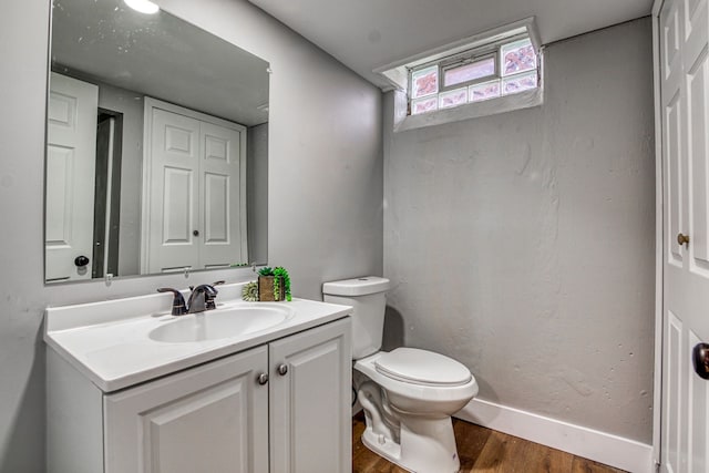 bathroom featuring vanity, hardwood / wood-style floors, and toilet