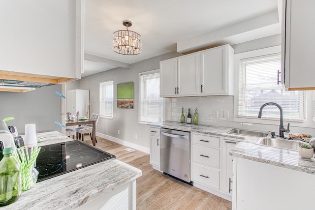 kitchen featuring sink, white cabinets, hanging light fixtures, stainless steel dishwasher, and light hardwood / wood-style floors