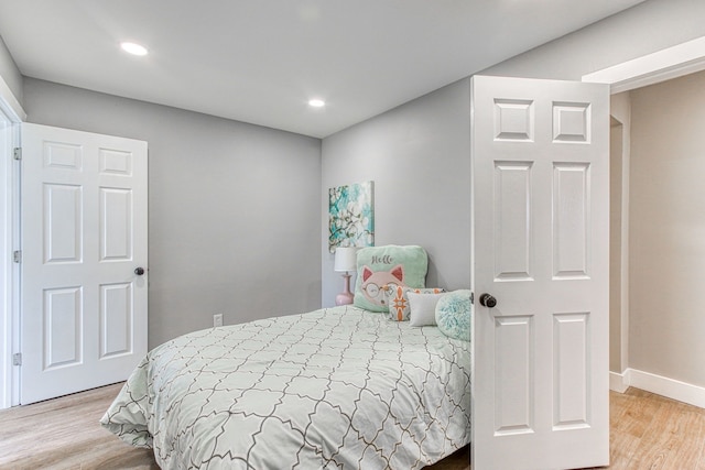 bedroom with hardwood / wood-style flooring