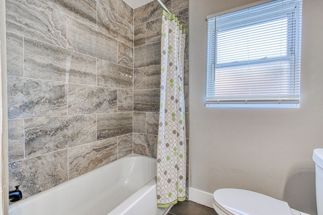 bathroom with toilet and shower / bathtub combination with curtain