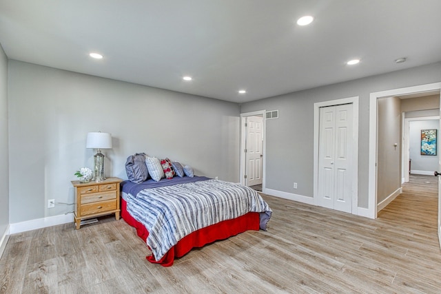 bedroom with a closet and light wood-type flooring