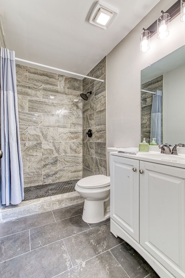 bathroom featuring vanity, toilet, and walk in shower