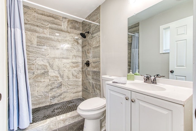 bathroom with vanity, toilet, and walk in shower