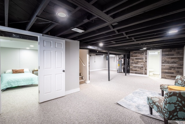 basement featuring water heater and carpet flooring