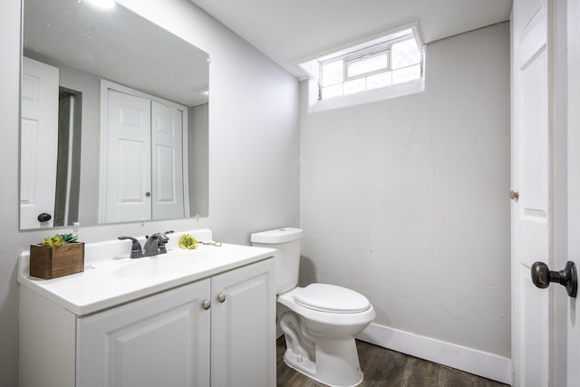 bathroom featuring vanity, toilet, and wood-type flooring