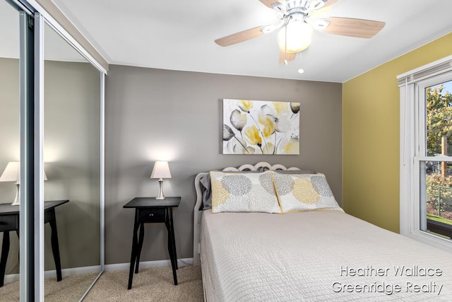 carpeted bedroom featuring multiple windows, a closet, and ceiling fan